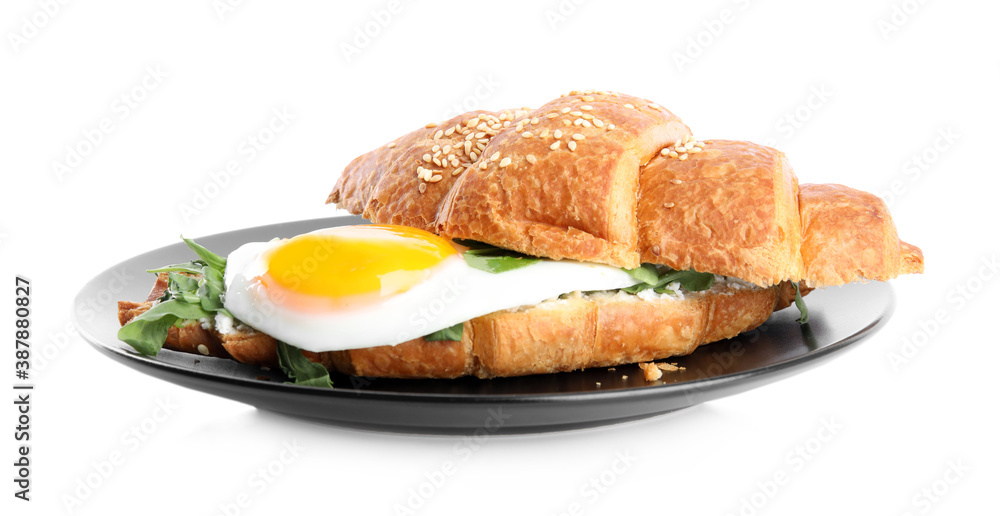 Delicious croissant with arugula and fried egg isolated on white Delicious croissant with arugula and fried egg isolated on white