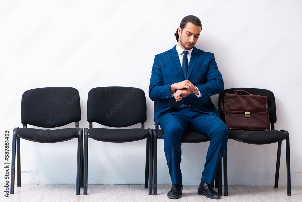 Young businessman waiting for an interview at hall Young businessman waiting for an interview at hall