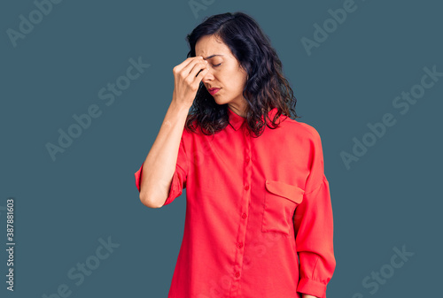 Young beautiful hispanic woman wearing casual clothes tired rubbing nose and eyes feeling fatigue and headache. stress and frustration concept.