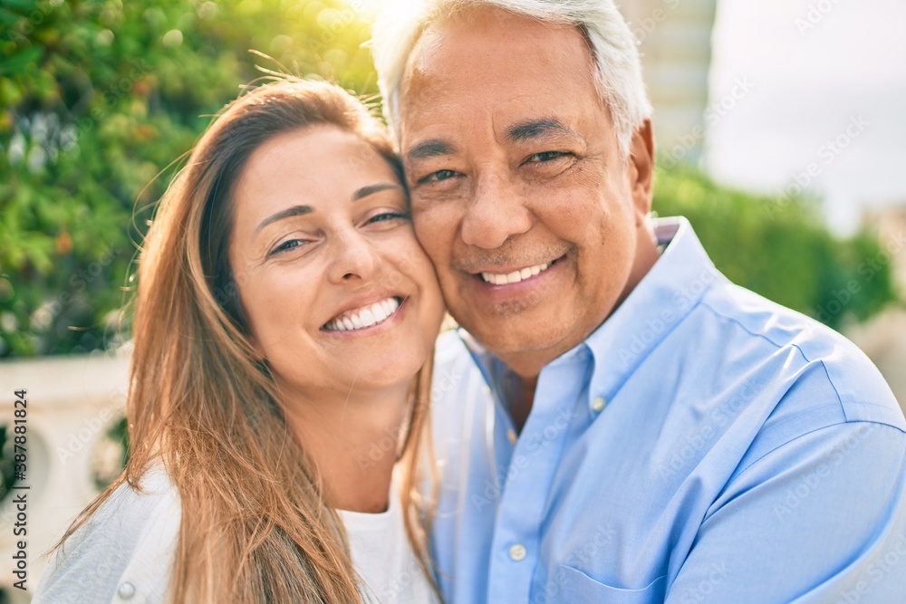 Middle age hispanic couple smiling happy hugging at the promenade. Middle age hispanic couple smiling happy hugging at the promenade.