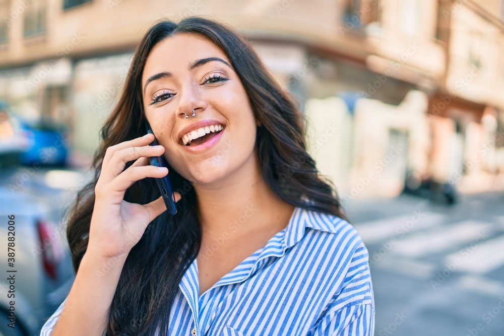 Young hispanic businesswoman smiling happy talking on the smartphone at the city. Young hispanic businesswoman smiling happy talking on the smartphone at the city.