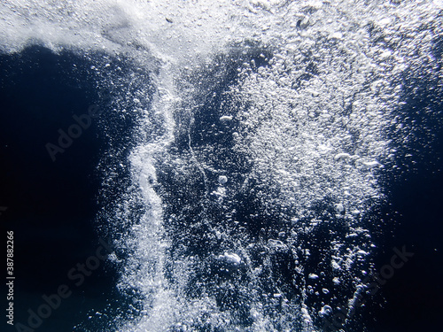 sea bubbles. dark sea waves from underwater with bubbles. Light rays shining through. Great for backgrounds. water bubble . Mediterranean sea bubble.dark underwater.waves foam background.Normal image