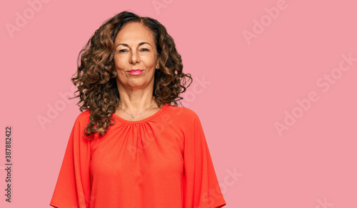 Fotografie Middle age hispanic woman wearing casual clothes with serious expression on face