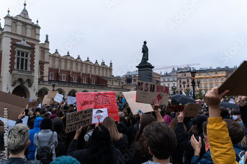 Obraz na płótnie Krakow, Poland - October 25, 2020: Polish people protest against a legislative proposal for a total ban of abortion in the main city center. The banner translates this is war w salonie