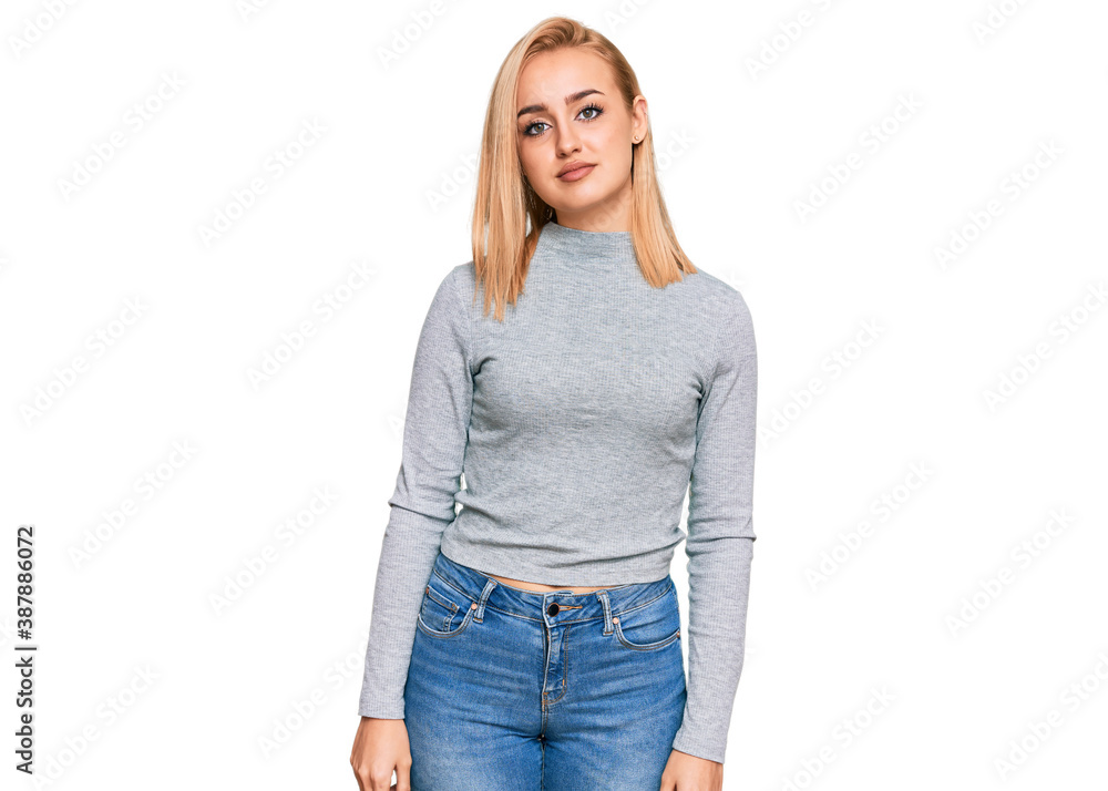 Beautiful caucasian woman wearing casual clothes relaxed with serious expression on face. simple and natural looking at the camera. Beautiful caucasian woman wearing casual clothes relaxed with serious expression on face. simple and natural looking at the camera.