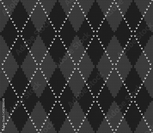 Knitted argyle Halloween pattern. Wool knitinng. Scottish plaid in gray and black rhombuses. Traditional  Scottish background of diamonds . Seamless fabric texture. Vector illustration