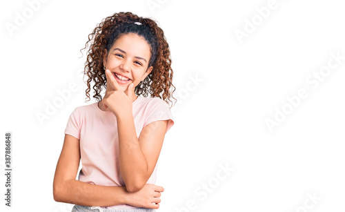Beautiful kid girl with curly hair wearing casual clothes looking confident at the camera smiling with crossed arms and hand raised on chin. thinking positive.