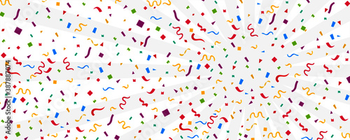 Streamers and confetti. Colourful tinsel and foil ribbons. Confetti falling rain on white background. . Elegant celebration concept. Background with many falling tiny confetti