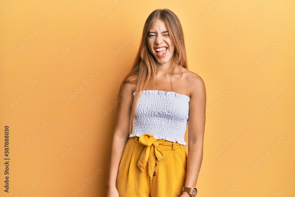 Beautiful young blonde woman wearing casual summer clothes winking looking at the camera with sexy expression, cheerful and happy face. Beautiful young blonde woman wearing casual summer clothes winking looking at the camera with sexy expression, cheerful and happy face.