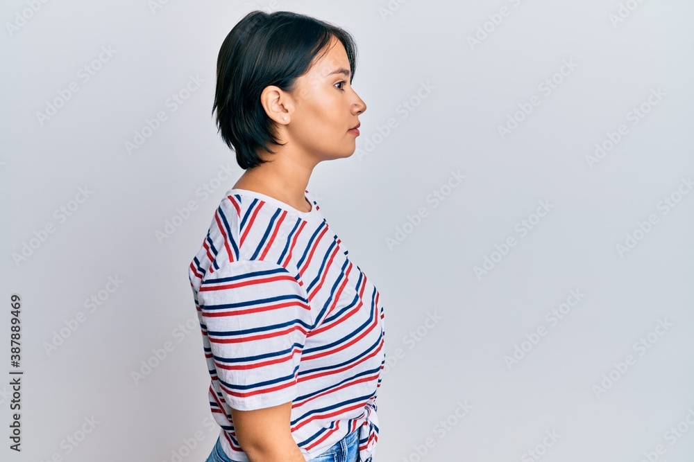 Beautiful young woman with short hair wearing casual clothes looking to side, relax profile pose with natural face with confident smile. Beautiful young woman with short hair wearing casual clothes looking to side, relax profile pose with natural face with confident smile.