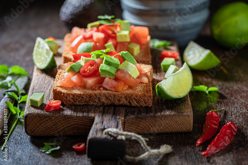 Homemade Toast with tomatoes, coriander and lime