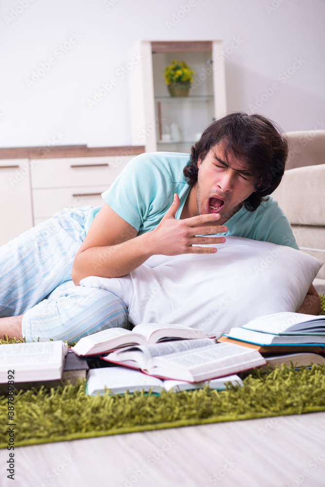 Young male student being tired preparing for exams at home Young male student being tired preparing for exams at home