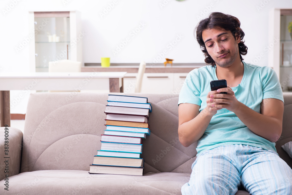 Young male student unhappy with excessive work at home Young male student unhappy with excessive work at home