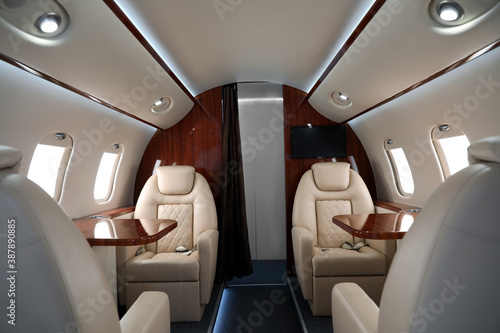 Airplane cabin with comfortable seats and tables © New Africa