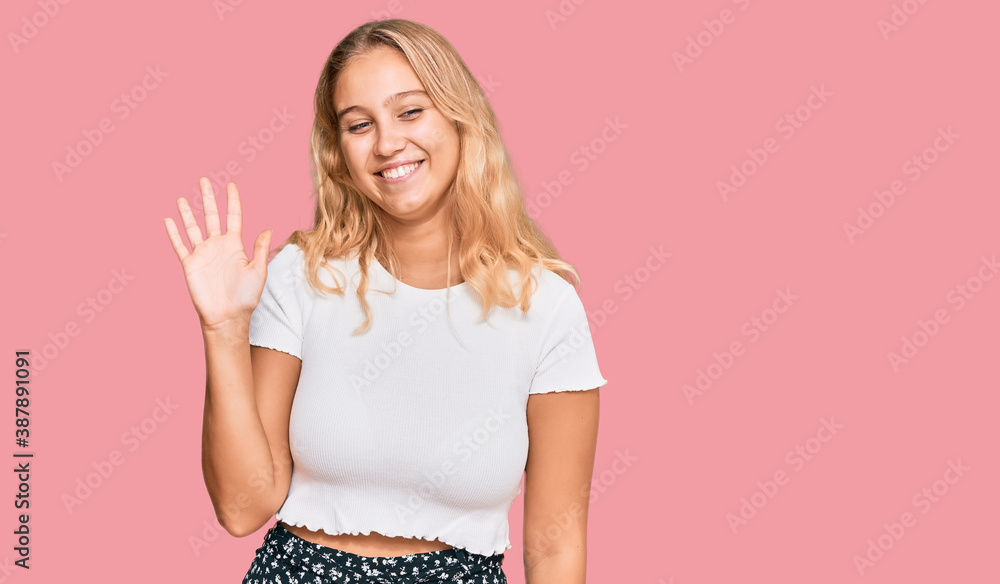 Young blonde girl wearing casual white tshirt showing and pointing up with fingers number five while smiling confident and happy. Young blonde girl wearing casual white tshirt showing and pointing up with fingers number five while smiling confident and happy.