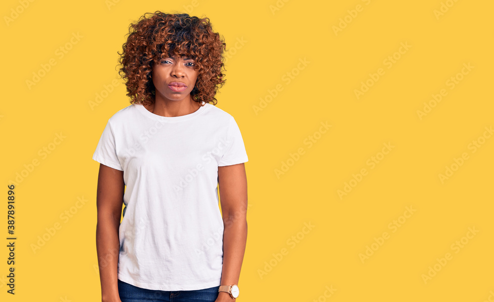 Young african american woman wearing casual white tshirt skeptic and nervous, frowning upset because of problem. negative person.