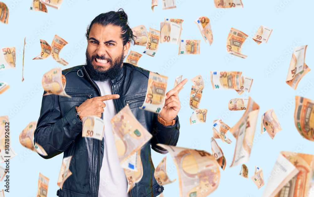 Young arab man wearing casual leather jacket pointing aside worried and nervous with both hands, concerned and surprised expression Young arab man wearing casual leather jacket pointing aside worried and nervous with both hands, concerned and surprised expression