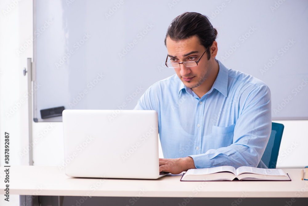 Young handsome teacher in tele-education concept Young handsome teacher in tele-education concept