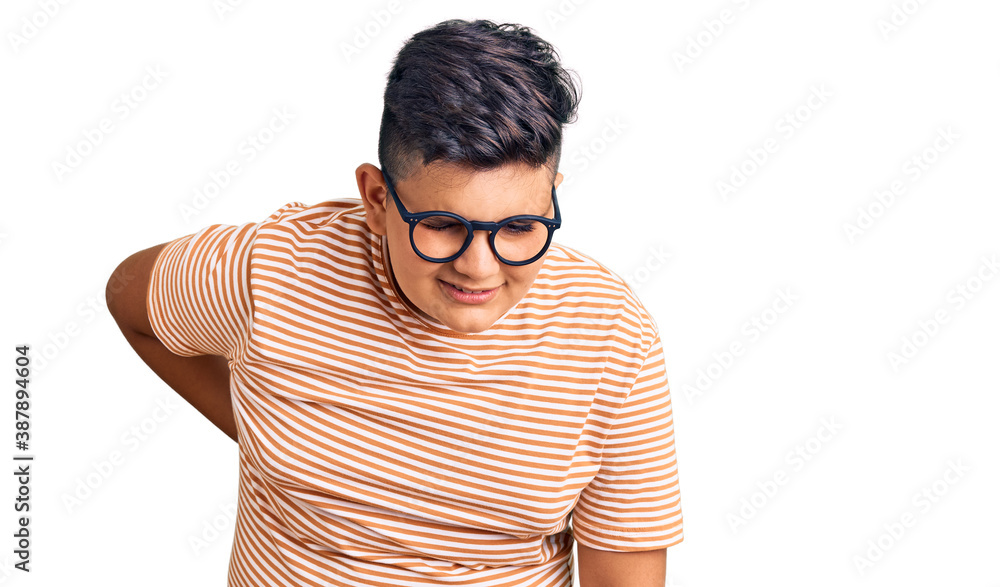 Little boy kid wearing casual clothes and glasses suffering of backache, touching back with hand, muscular pain Little boy kid wearing casual clothes and glasses suffering of backache, touching back with hand, muscular pain