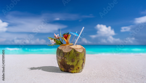 Fototapeta Naklejka Na Ścianę i Meble -  Coconut drink on a sandy beach