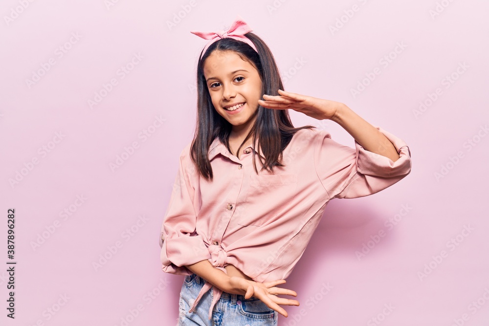 Beautiful child girl wearing casual clothes gesturing with hands showing big and large size sign, measure symbol. smiling looking at the camera. measuring concept. Beautiful child girl wearing casual clothes gesturing with hands showing big and large size sign, measure symbol. smiling looking at the camera. measuring concept.