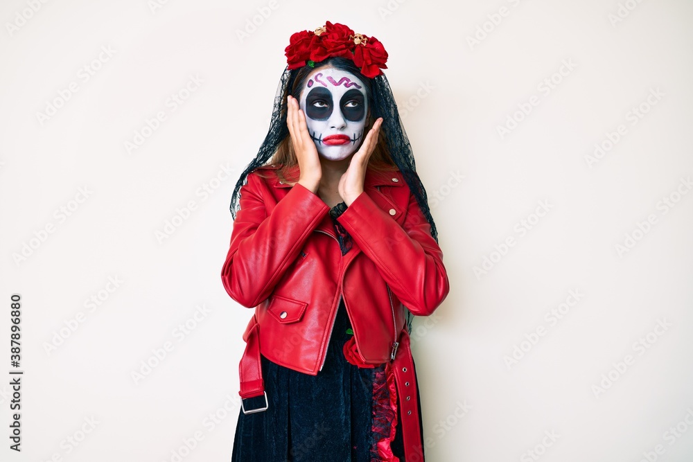 Fototapeta premium Woman wearing day of the dead costume over white tired hands covering face, depression and sadness, upset and irritated for problem