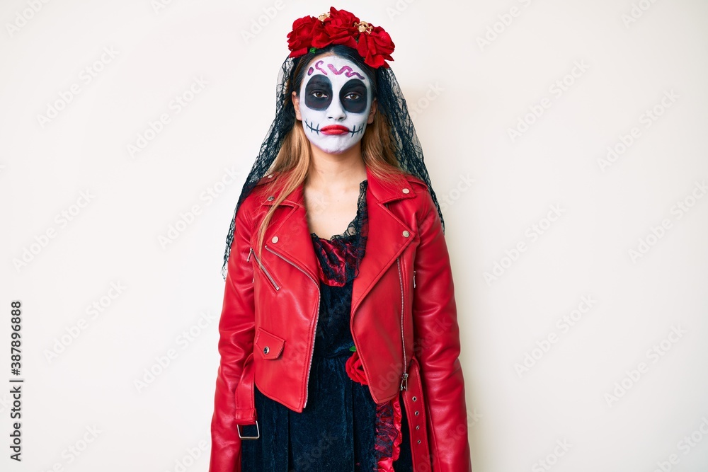 Woman wearing day of the dead costume over white looking sleepy and tired, exhausted for fatigue and hangover, lazy eyes in the morning. Woman wearing day of the dead costume over white looking sleepy and tired, exhausted for fatigue and hangover, lazy eyes in the morning.