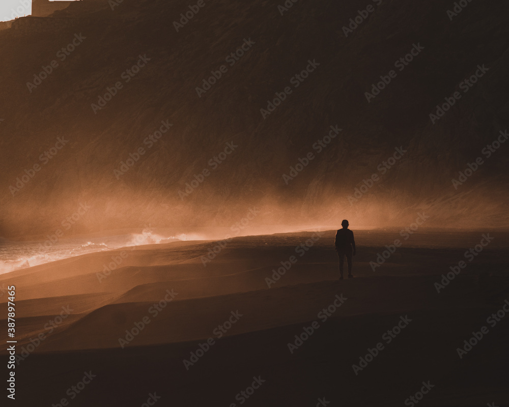 Woman in dark sunset walking at Mexican beach