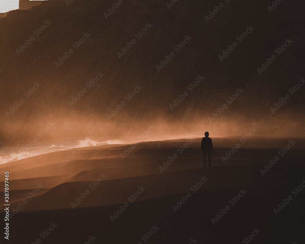Woman in dark sunset walking at Mexican beach Woman in dark sunset walking at Mexican beach