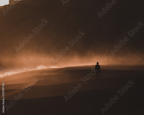 Woman in dark sunset walking at Mexican beach