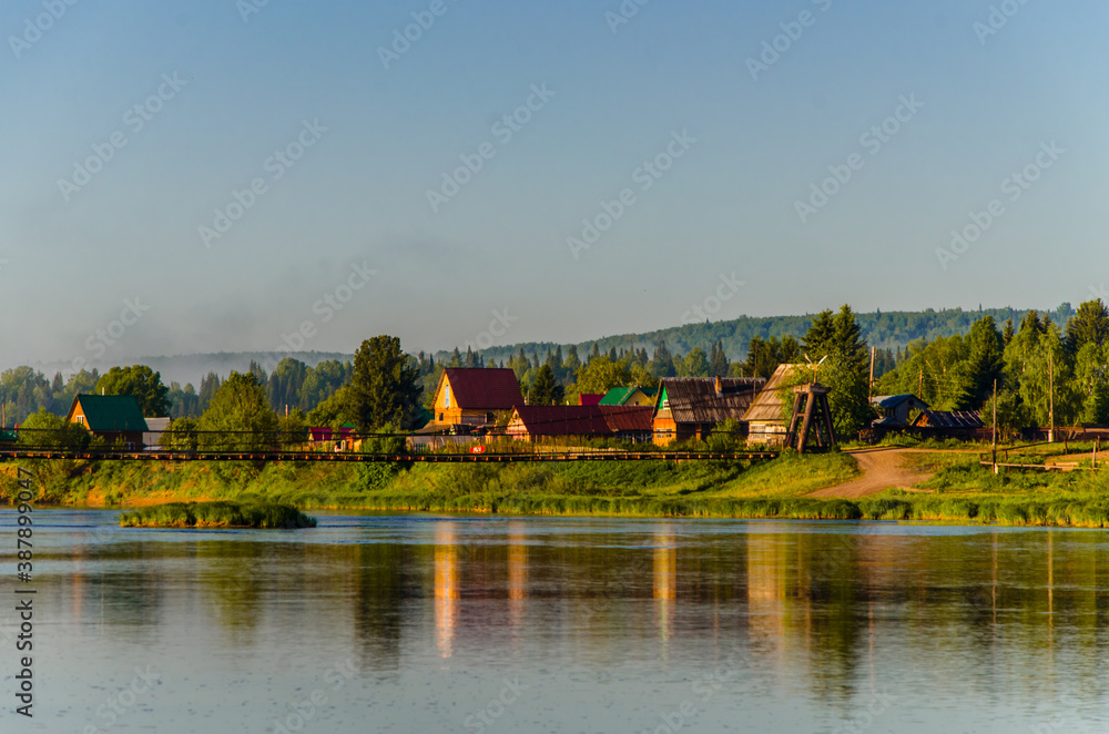 houses on the beach. Rural river in the early morning