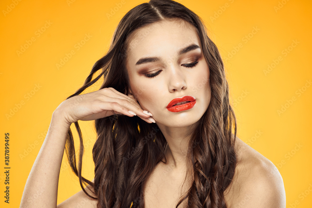 Woman with bare shoulders red cropped lips charm yellow background Woman with bare shoulders red cropped lips charm yellow background