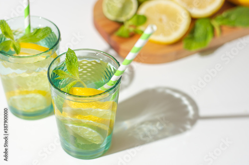 Summer drinks with lemon and fresh mint on rustic background.