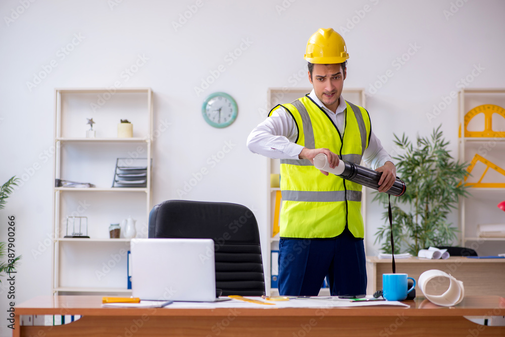 Young male architect working in the office Young male architect working in the office