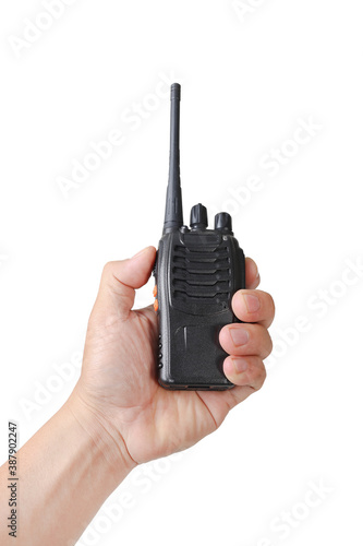 The hand of a man holding a walkie-talkie isolated on white background with clipping path photo