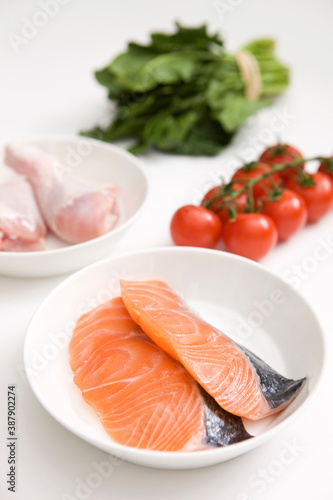 slice of salmon and chicken with vegetables