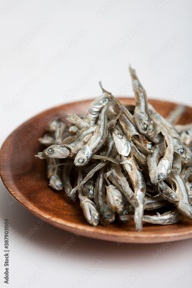 dried anchovies on wooden plate dried anchovies on wooden plate