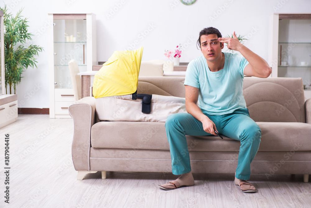 Young male parent looking after newborn at home Young male parent looking after newborn at home