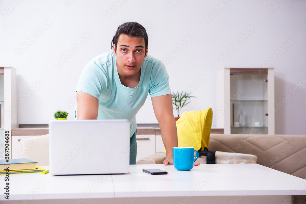 Young male parent looking after newborn at home Young male parent looking after newborn at home