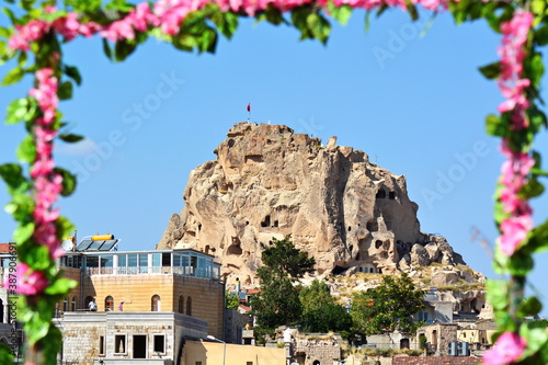 Rear side of antique fortress Uchhisar in Pigeon valley, Goreme, Cappadocia, Turkey photo