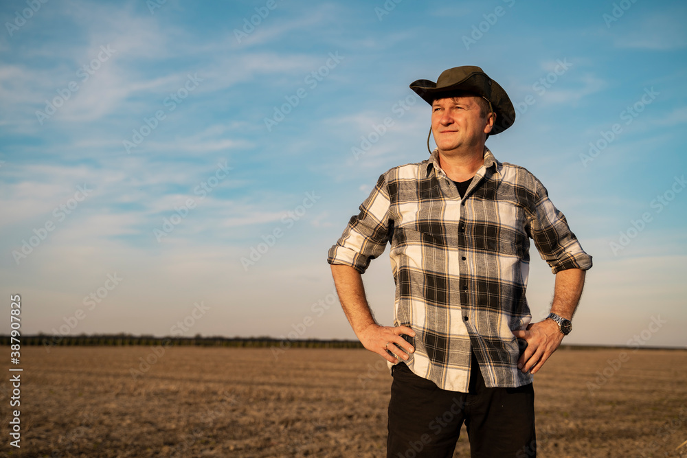 Farmer with hat standing proudly on his soil Farmer with hat standing proudly on his soil