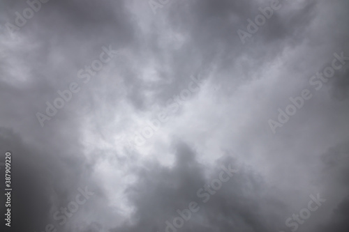 black and white storm clouds background. Light in the Dark and Dramatic Storm Clouds background  Dark clouds before a thunder-storm.