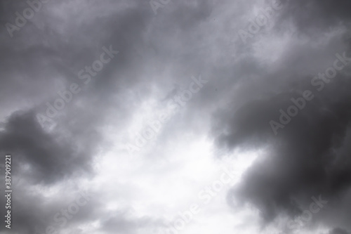 black and white storm clouds background. Light in the Dark and Dramatic Storm Clouds background, Dark clouds before a thunder-storm.