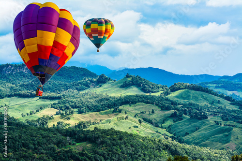 Colorful hot air balloons flying over mountain at pai mae hong son Thailand.