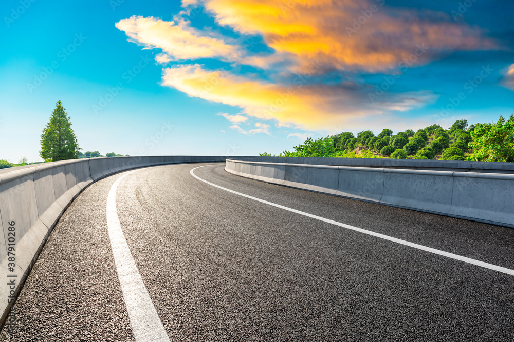 Fototapeta premium Countryside asphalt road and green tea plantations with mountain natural scenery in Hangzhou at sunrise.