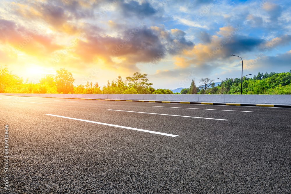 Fototapeta premium Countryside asphalt road and green plants with mountain natural scenery in Hangzhou at sunrise.