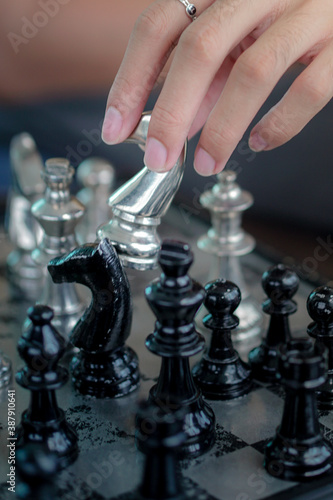 close-up of hand playing chess