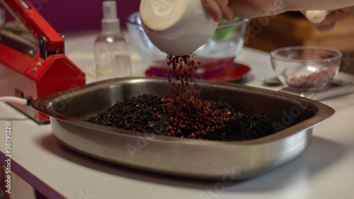 close up of a woman making a tea blend