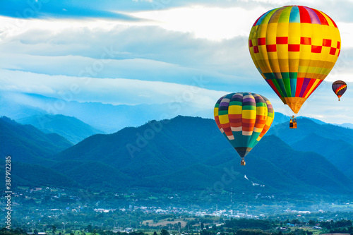 Colorful hot air balloons flying over mountain at pai mae hong son Thailand.