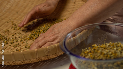 close up of a woman making a tea blend